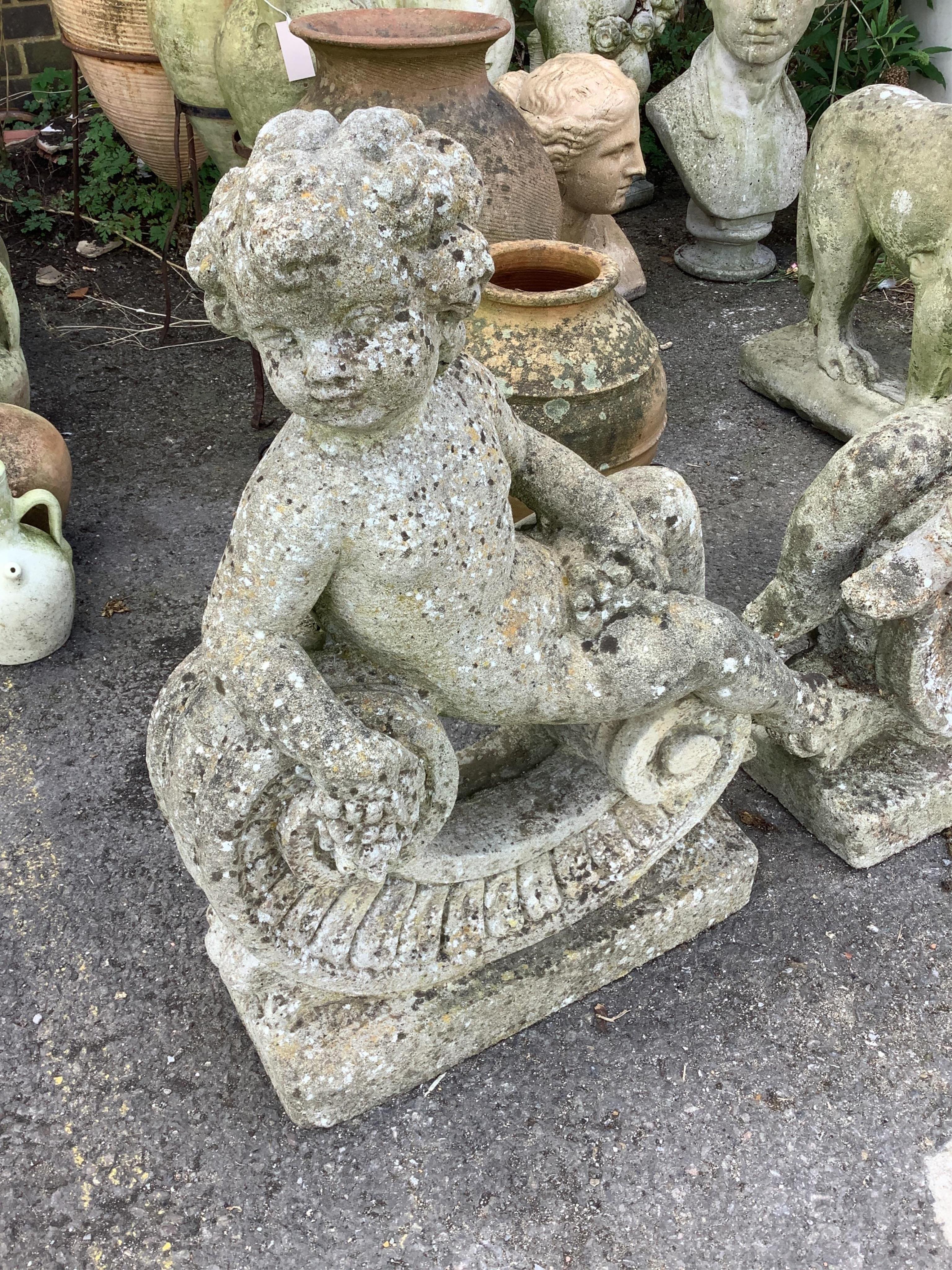 A pair of reconstituted stone putti and scroll garden ornaments, height 68cm. Condition - poor to fair